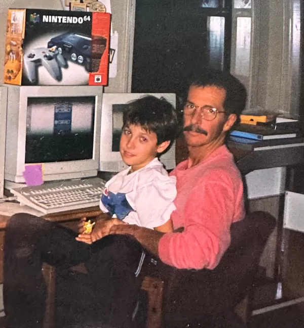 Chris Maple in his home office with his son